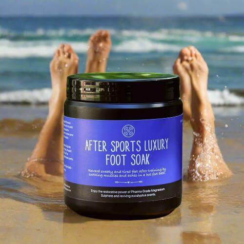 Luxury foot soak by ZestySpiritz in a clear container, set against a serene seaside backdrop.