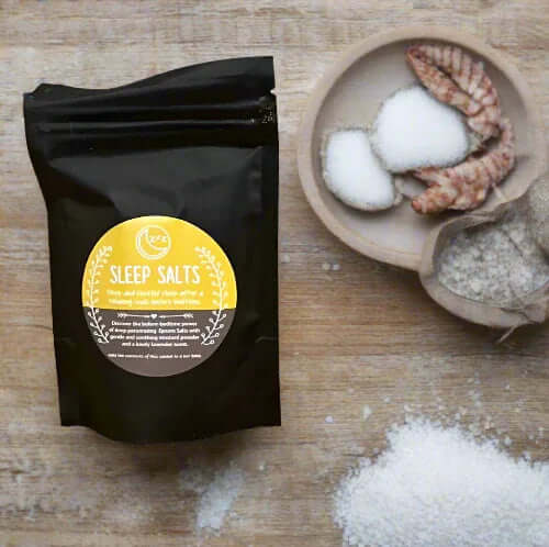 Better Sleep Salt Soaks package with salt and shells on wooden table for ultimate relaxation.