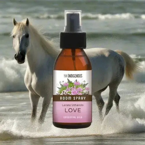 ZestySpiritz Love Room Spray 100ml in an elegant bottle, surrounded by floral elements in a serene setting.