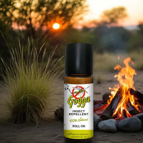 Natural Insect Repellent Roll-On 10ml displayed by a campfire at sunset, made with South African essential oils.