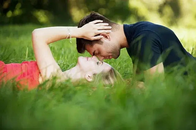 Romantic couple sharing an intimate moment in nature, symbolizing passion and connection for sexual health supplements.